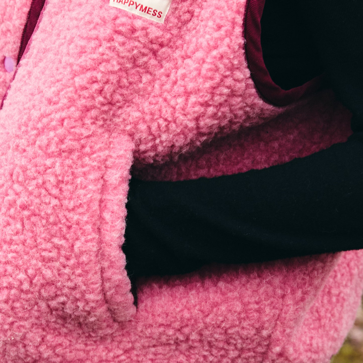 Detail of pink merino wool vest pocket and stitching, premium European-made merino wool vest