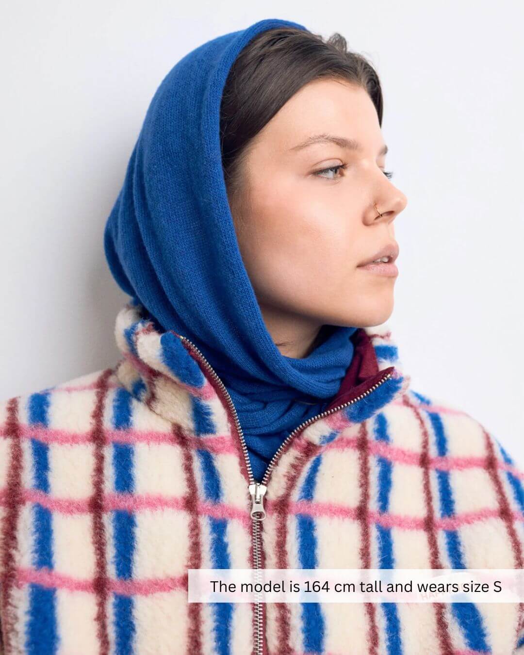 Model wearing a pink and cobalt 100% merino wool jacket, featuring a stand-up collar and metal zipper.