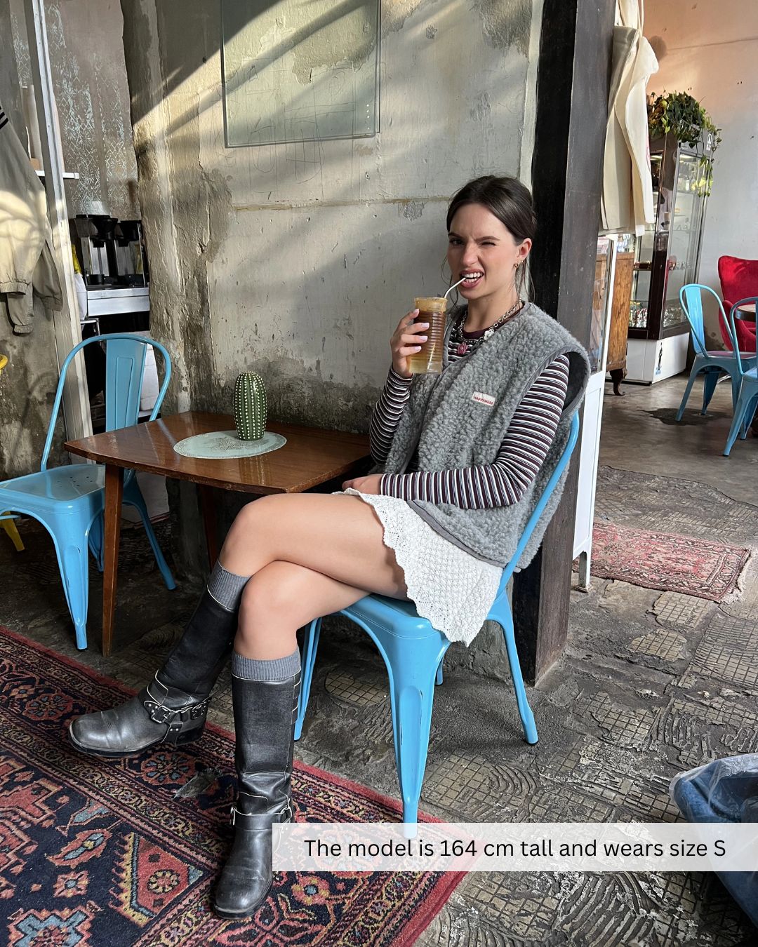 Woman wearing a merino wool vest in a city setting, stylish merino wool vest for everyday wear