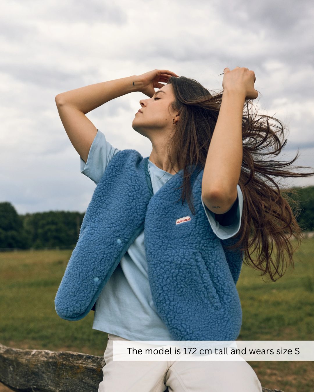 Woman wearing a blue merino wool vest in a relaxed outfit, soft merino wool vest for everyday comfort