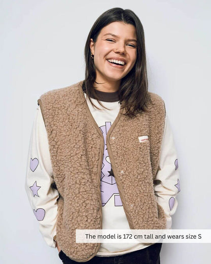 Woman wearing brown merino wool vest by Mewomee, breathable European-made merino clothing for everyday wear in Canada